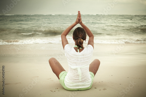 Woman doing yoga on Punta Cana beach.