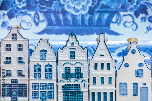 Dutch Delft blue souvenir houses in front of an old plate