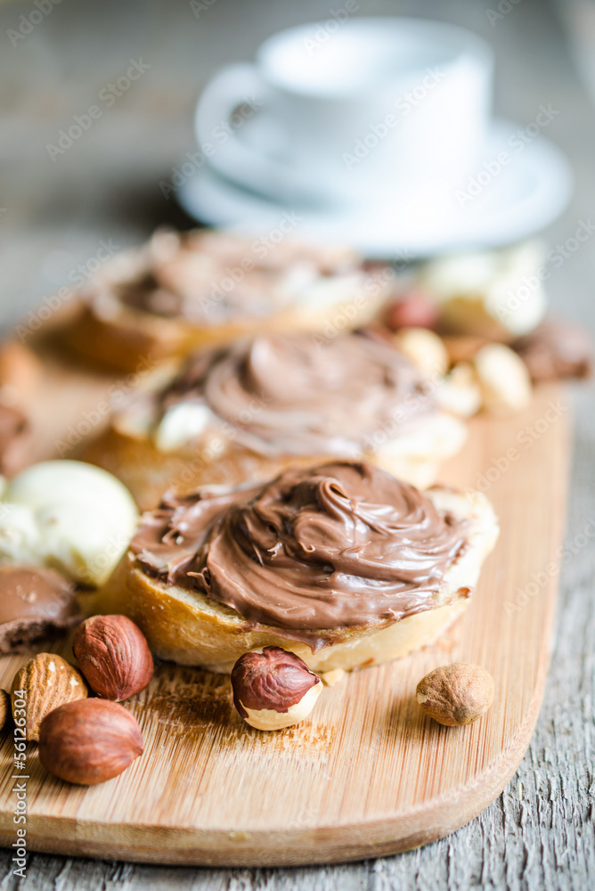 Slices of bread with chocolate cream and nuts