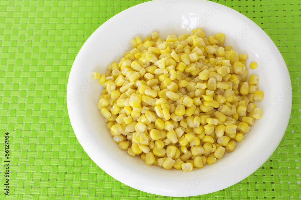grains of corn on green tablecloth grains of corn on green tablecloth