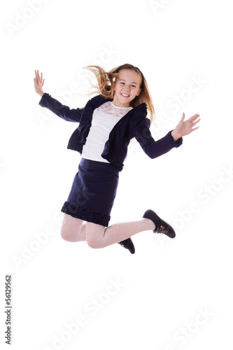 Happy schoolgirl in uniform jumping