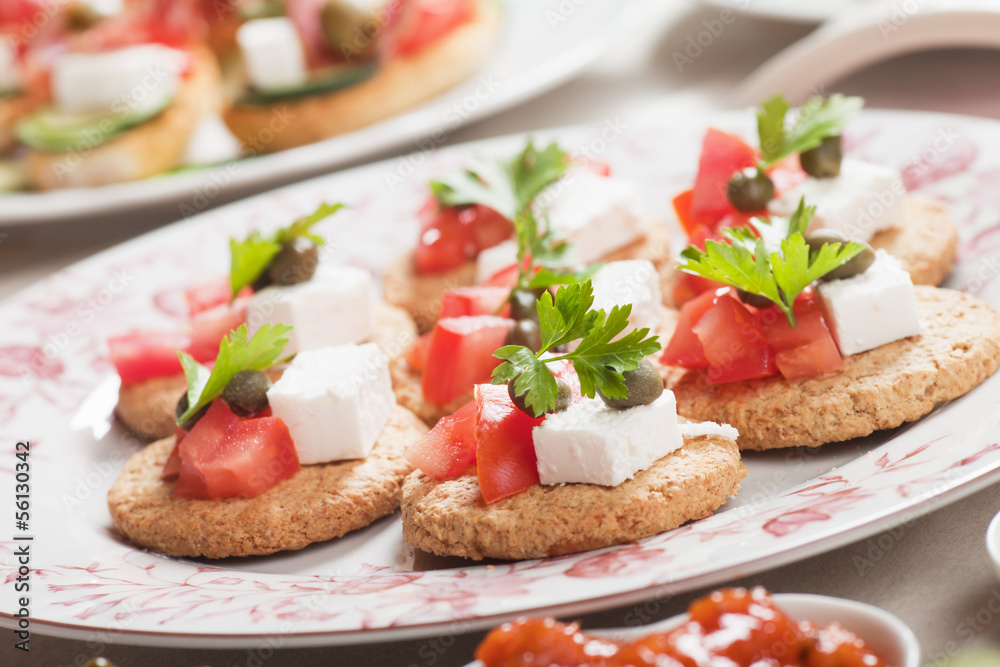 Canape with tomato and feta cheese