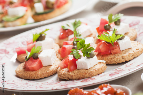 Canape with tomato and feta cheese