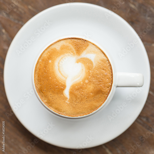 close up a cup of coffee on wooden table