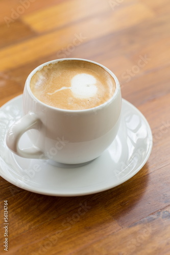 close up a cup of coffee on wooden table