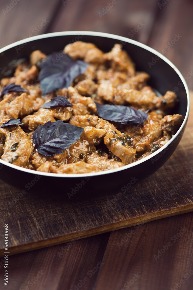 Roasted pork with basil leaves, close-up, vertical shot Roasted pork with basil leaves, close-up, vertical shot