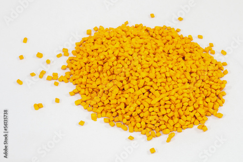 Obraz na płótnie yellow plastic polymer granules on white background
