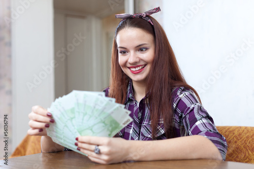 girl with many euro in home
