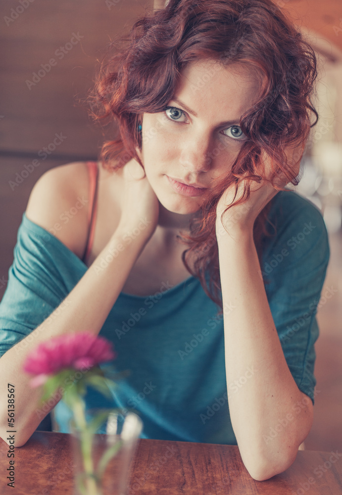 Obraz premium Vintage toned Redhead sitting in the cafee