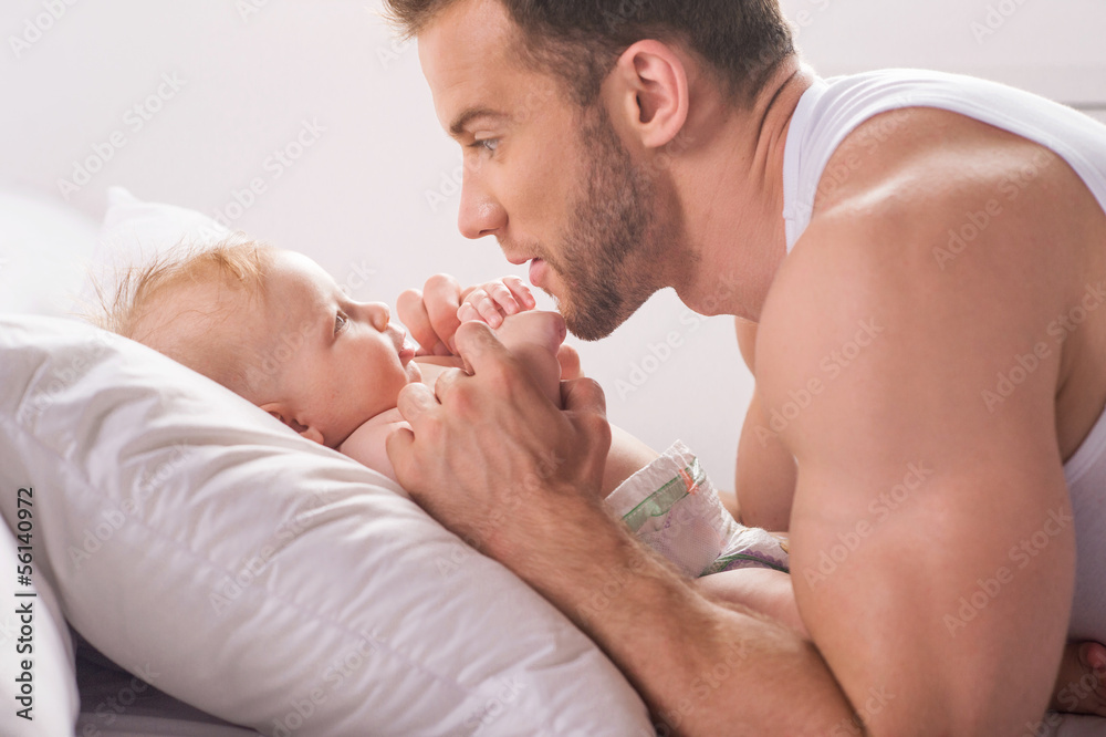 Man with little baby. Young muscular father and little baby havi Man with little baby. Young muscular father and little baby havi