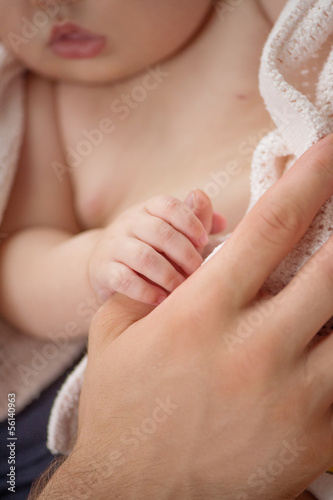 Father with baby. Little baby holding fathers finger and sleepin