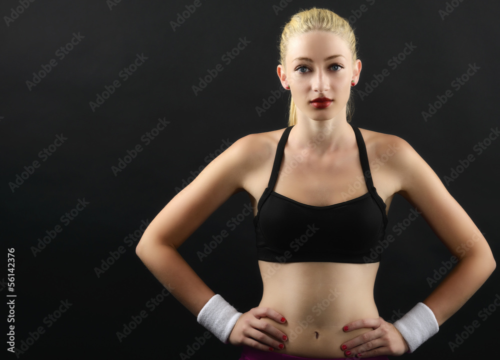 Obraz premium Portrait of a sexy fitness woman isolated on black