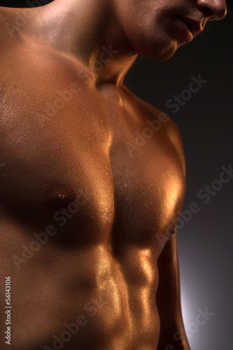 Muscular man. Close-up of muscular man standing isolated on whit