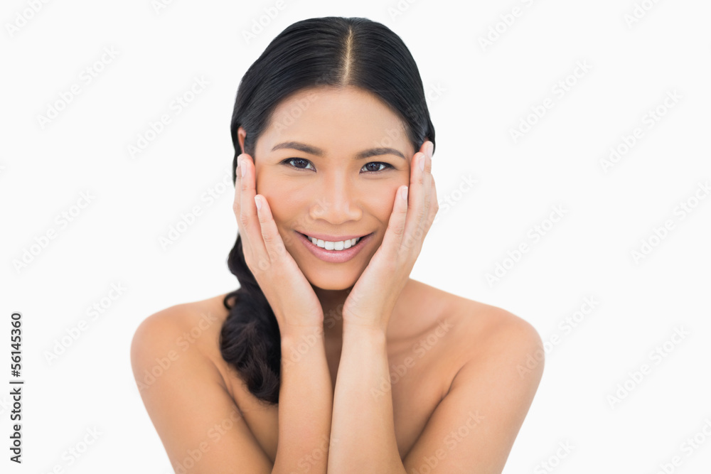 Smiling sensual dark haired model touching her face Smiling sensual dark haired model touching her face