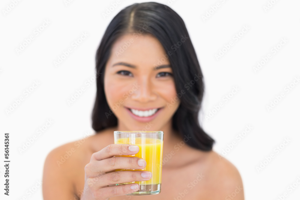 Smiling sensual nude model drinking orange juice Smiling sensual nude model drinking orange juice