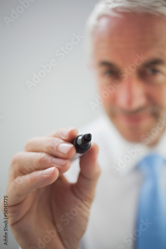 Close up of a concentrated businessman holding a marker