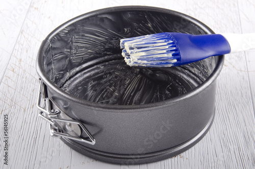 baking tin is greased with butter