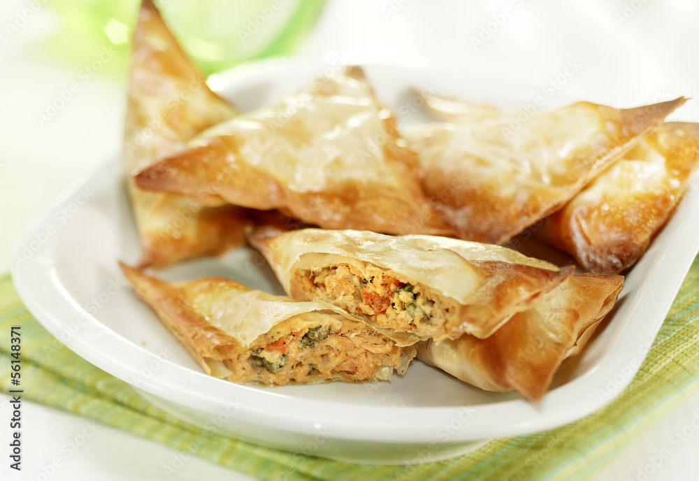 patties filled with salmon served on a white plate