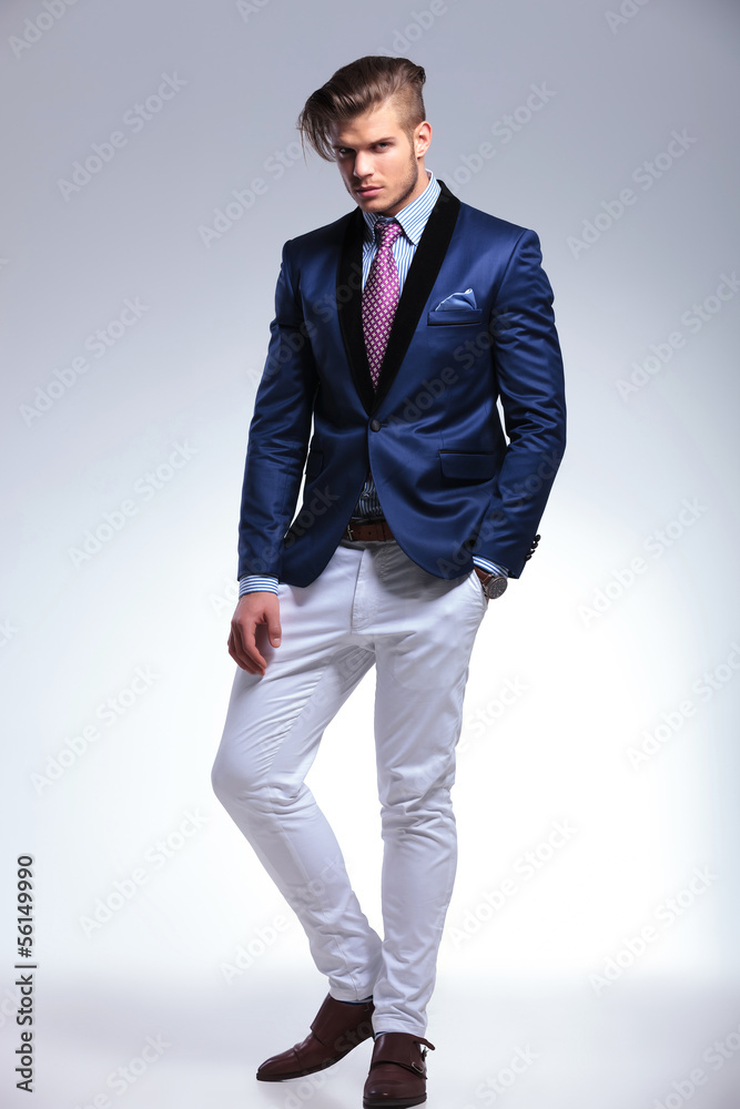 young business man poses with a hand in his pocket young business man poses with a hand in his pocket