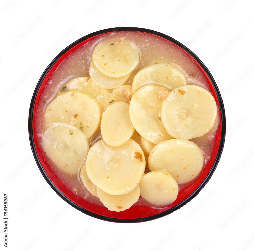 A serving of German potato salad on a red plate