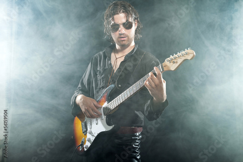 Psychedelic rock guitarist with long brown hair and beard. Weari