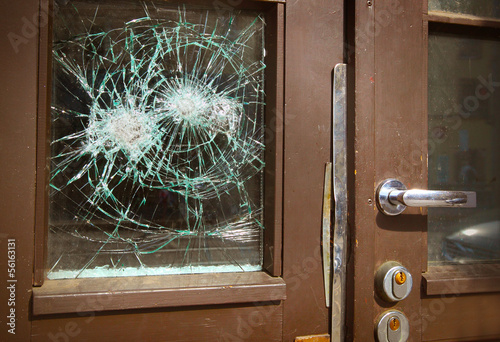 Broken window on  door by vandalism