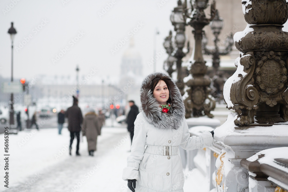 Smiling girl enjoying rare snowy day in Paris