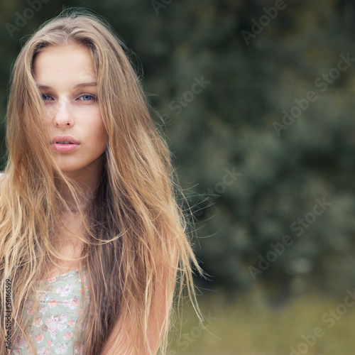 portrait of a beautiful blonde outdoors in the park