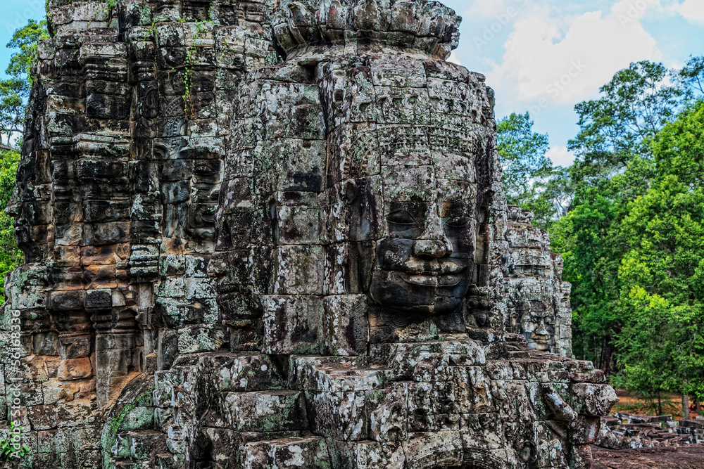 A stone sculpture of Buddha in the temple of Bayon in Cambodia