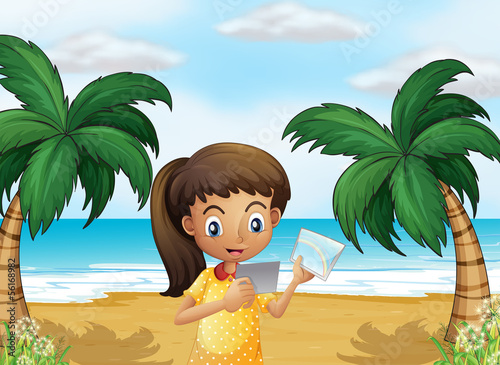 A girl holding pictures at the beach