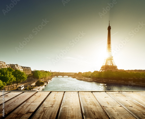 background with wooden deck table and  Eiffel tower in Paris © Iakov Kalinin