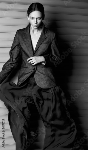 Fashion women dinamic move in suit on gray background