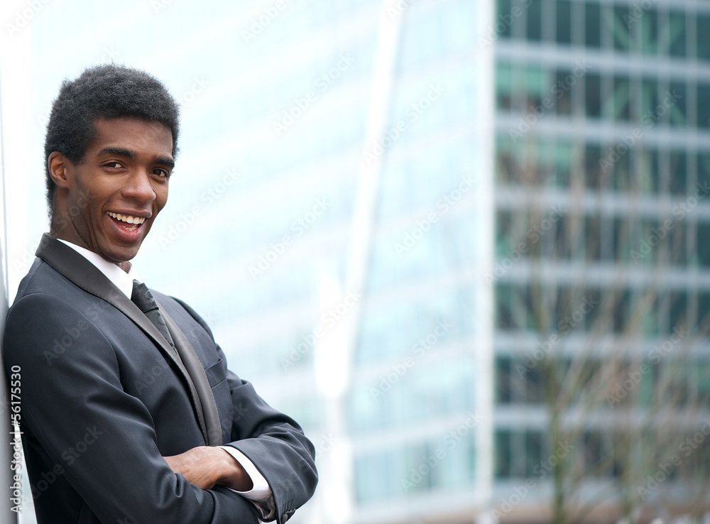 Cheerful young businessman smiling in the city Cheerful young businessman smiling in the city