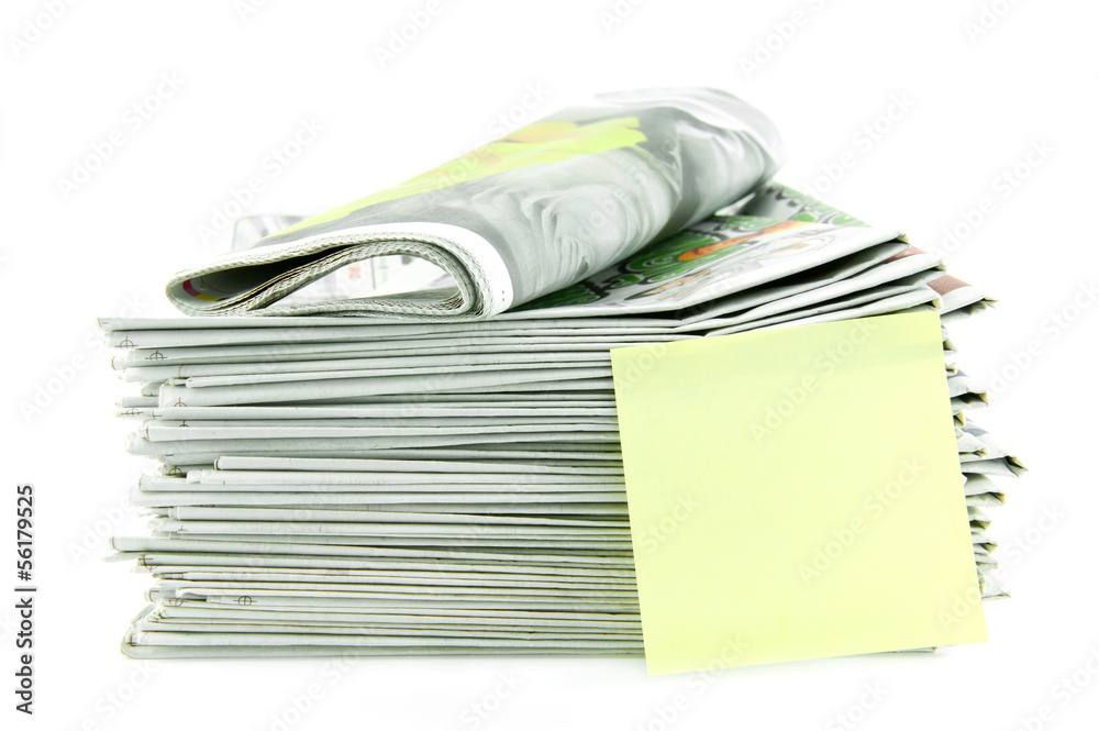 pile of newspaper with yellow stick note isolated on white backg pile of newspaper with yellow stick note isolated on white backg