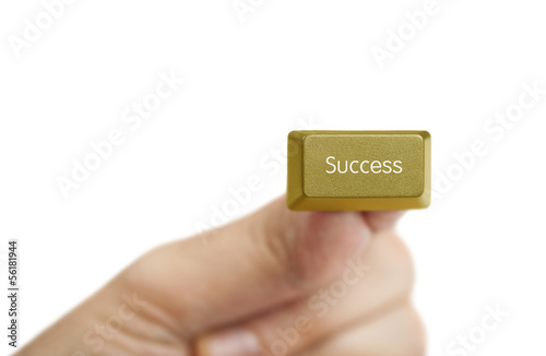 hand holding golden success computer key