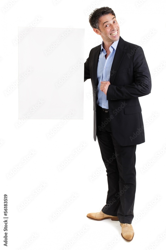 Smiling businessman holding a blank white sign Smiling businessman holding a blank white sign