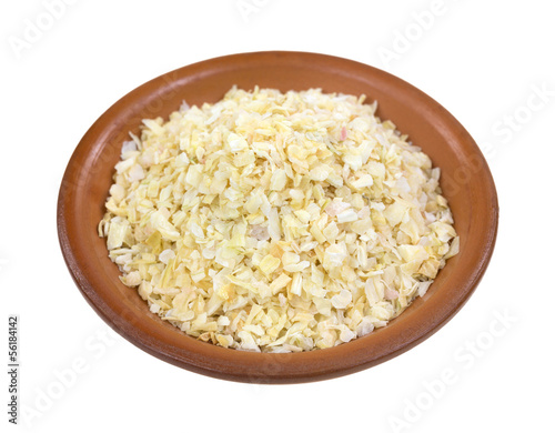 Vászonkép Dried minced onions in a red clay bowl