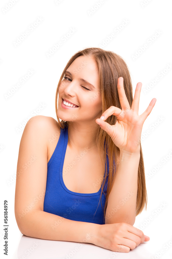 Portrait of a smiling woman showing OK sign Portrait of a smiling woman showing OK sign