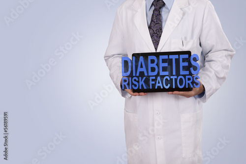 A medical professional holds a tablet displaying the words Diabe