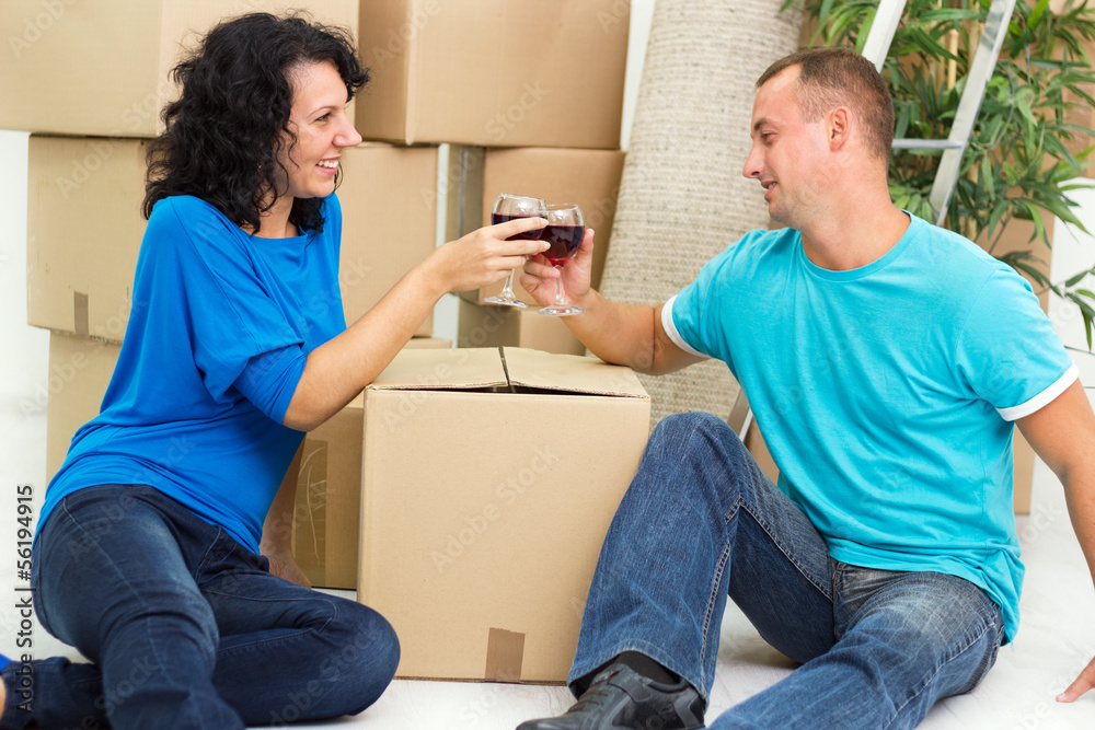 Young couple having a toast in new home Young couple having a toast in new home