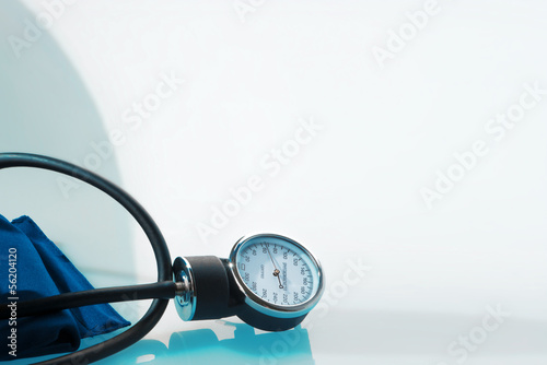 Sphygmomanometer on blue, reflective background