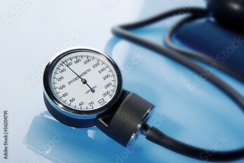 Sphygmomanometer on blue background