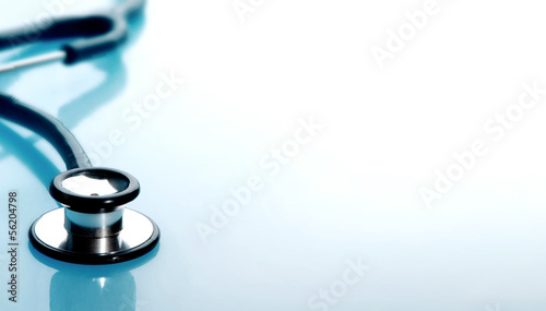 Stethoscope on blue, reflective background