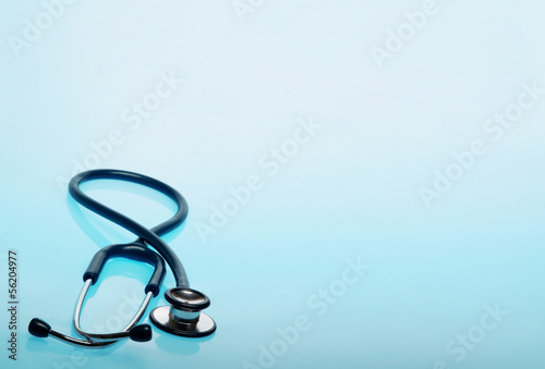 Stethoscope on blue, reflective background