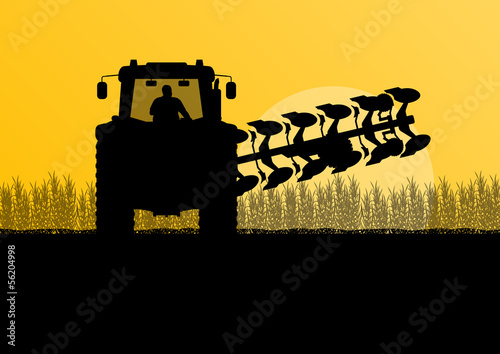 Agriculture tractor plowing the land in cultivated country grain
