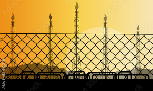 Wired fence and oil refinery industrial factory desert landscape