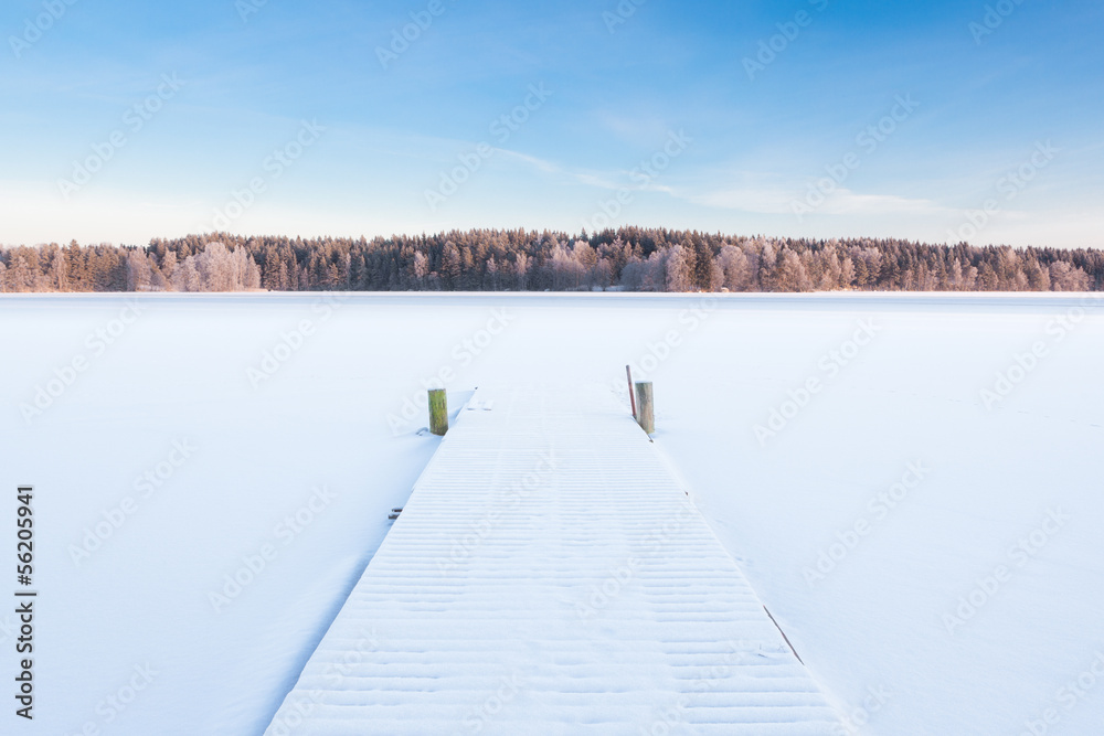 Fototapeta premium frozen snowy lake and a pier
