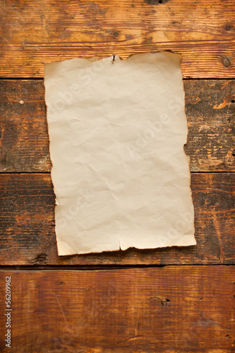 old blank paper nailed to a plank door