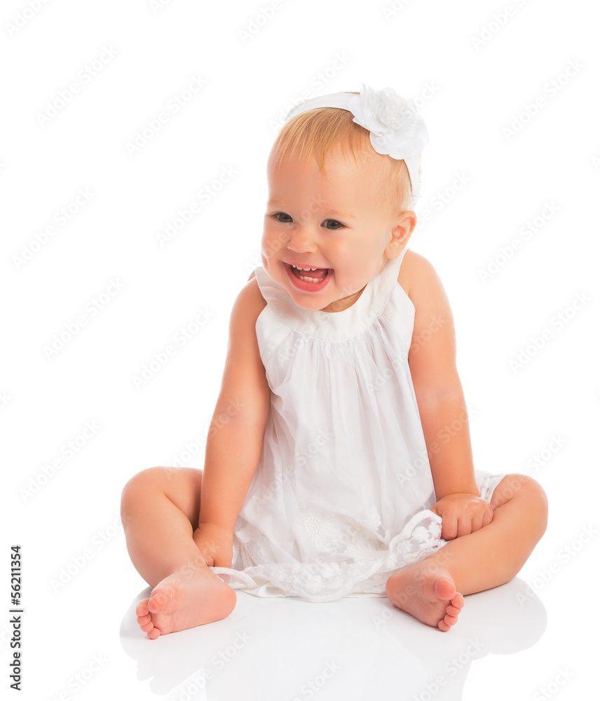 happy little baby girl in white dress laughs isolated on white