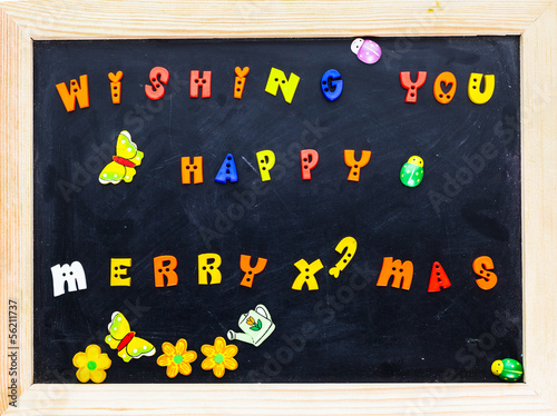 Color merry christmas words on black board.
